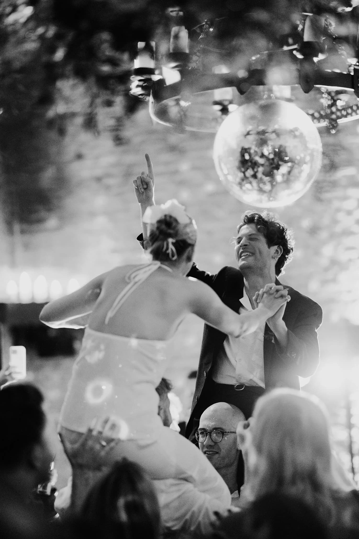 A couple dancing under a disco ball at their wedding