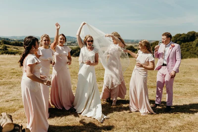 Bridal party celebrating in a field